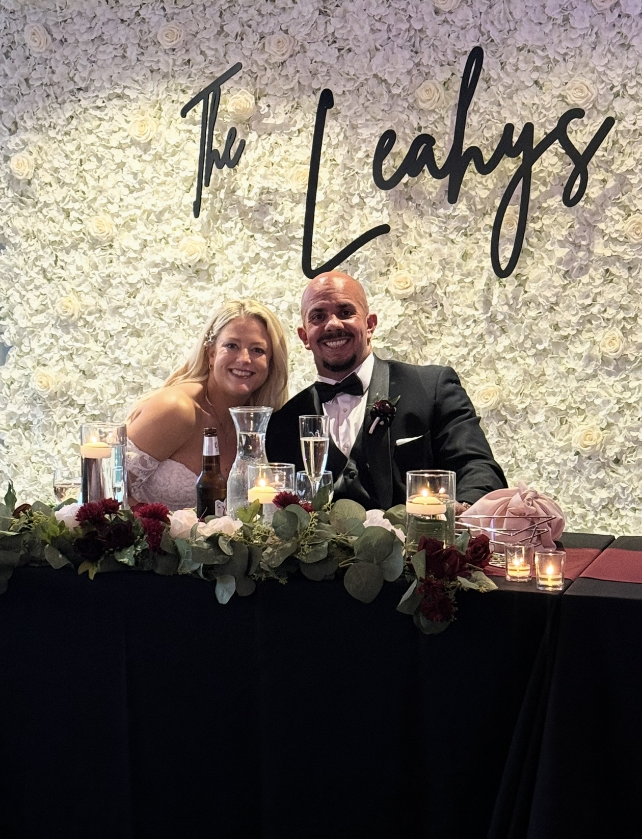 White flower wall behind the photo booth at the Leahys' wedding